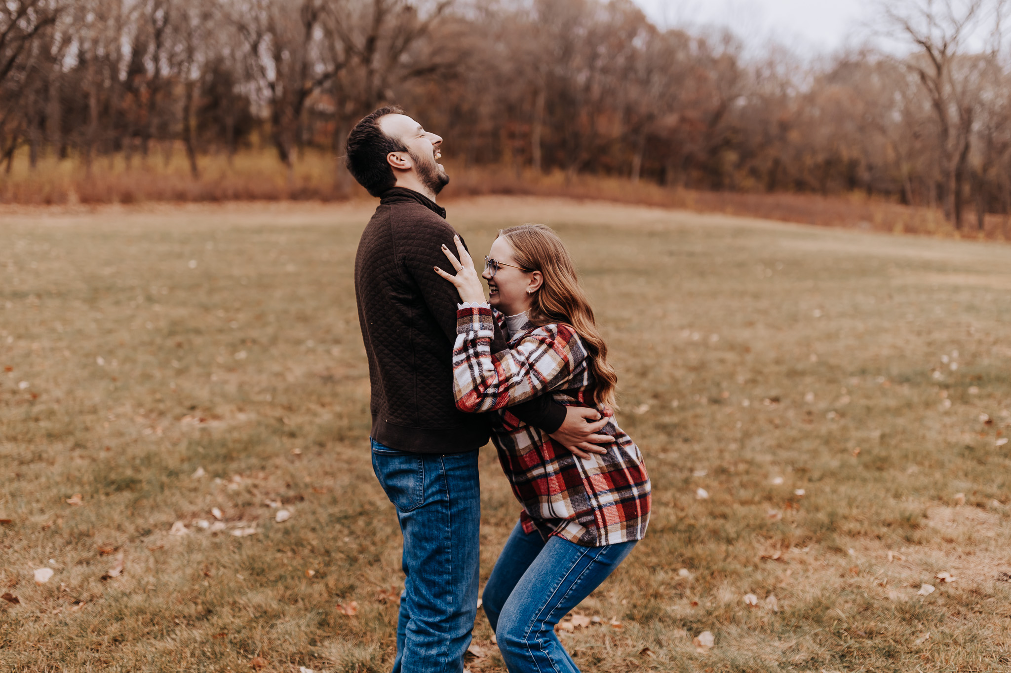 Caught mid-laugh, this playful moment shows how much fun an engagement session can be in wide-open nature.