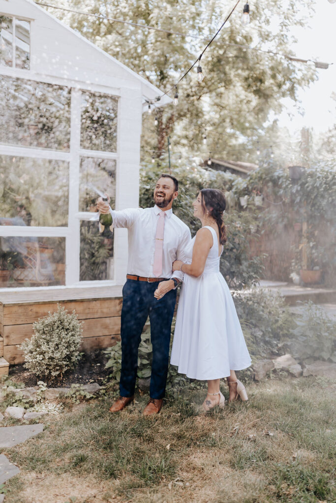 Nashville elopement photographer captures bride and groom celebrating how to elope in Nashville with champagne pop