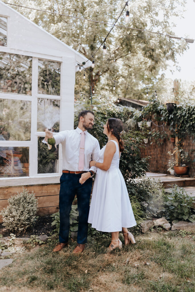 Nashville elopement photographer captures recently married couple celebrating with champagne pop