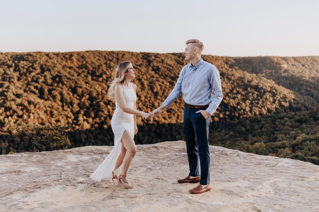 Destination Wedding Photographer captures bride and groom standing on mountain during Colorado elopement