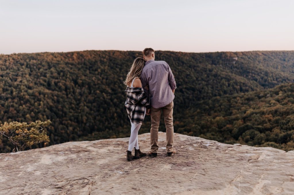 A couple looking off at the moon. Tennessee Mountain Sunset Engagement