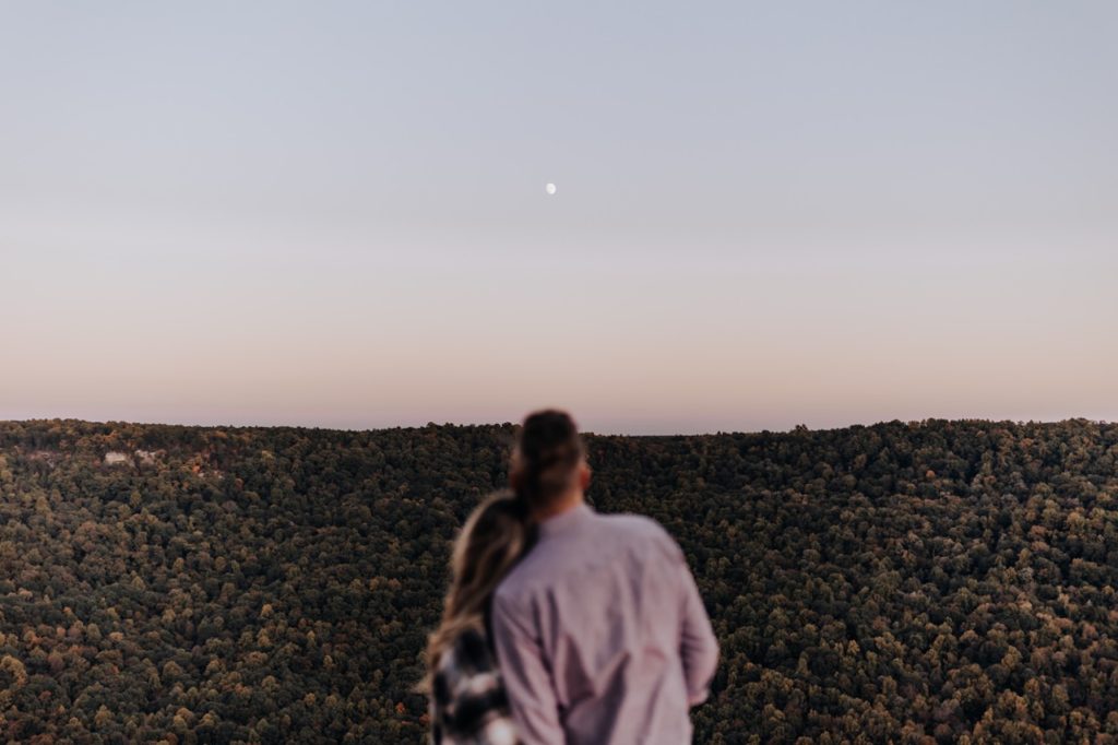 A couple looking off at the moon. Tennessee Mountain Sunset Engagement