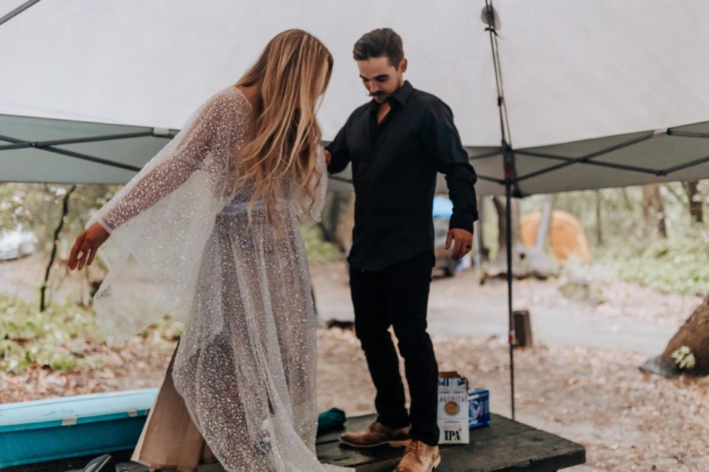 A couple dancing under a tent in their wedding attire. Big Sur Sunset Elopement
