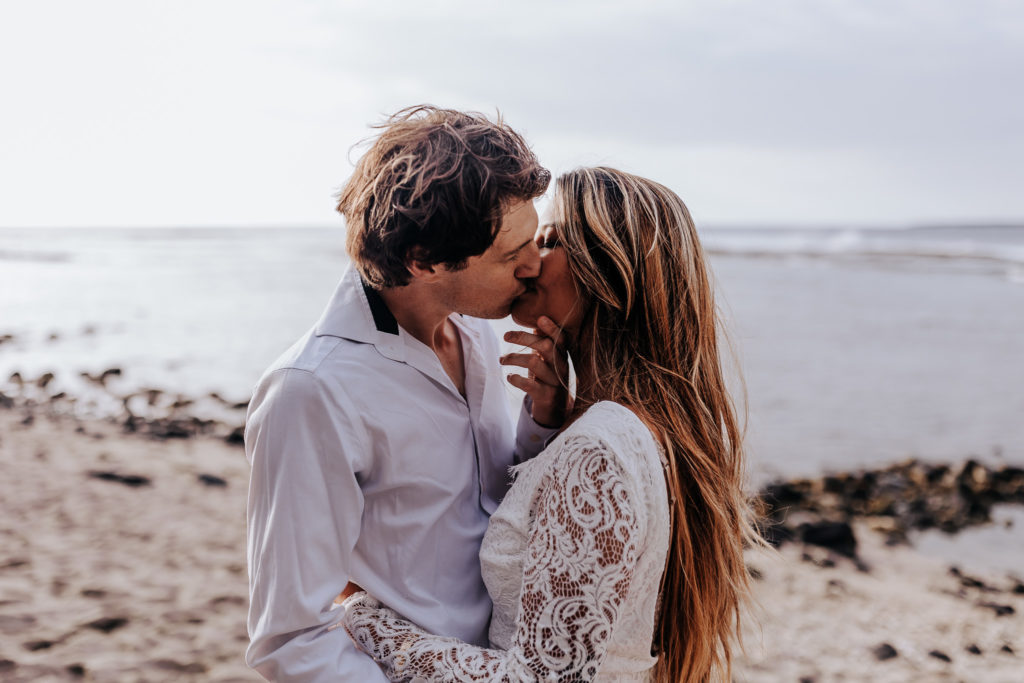 a couple kissing on the beach. big island beach elopement