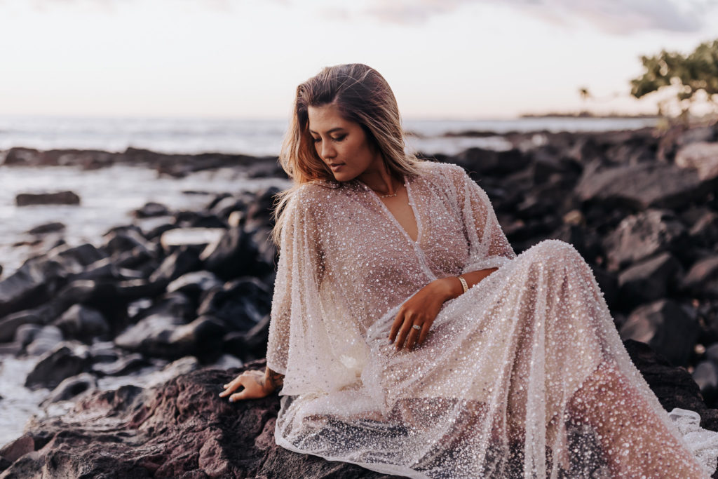 Destination Wedding Photographer captures woman on rocks in beach
