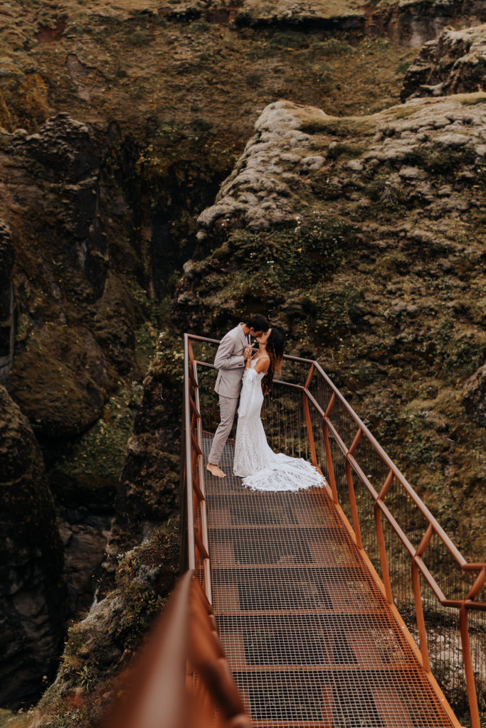 Destination elopement photographer captures couple on bridge after Iceland elopement