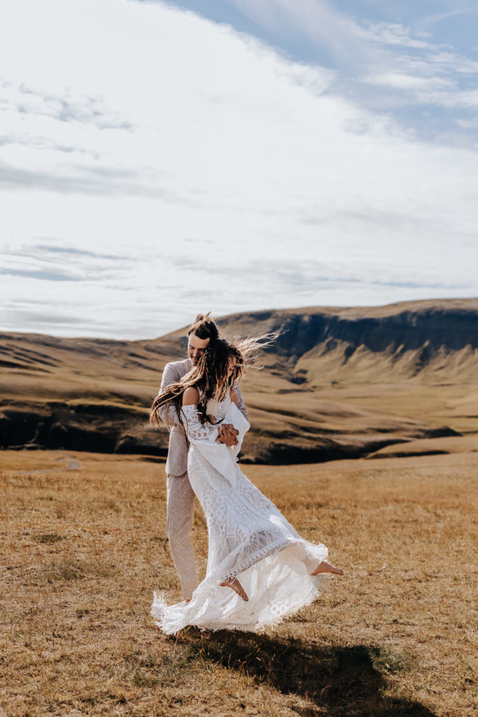 Iceland elopement photographer captures couple dancing on cliff after Iceland elopement