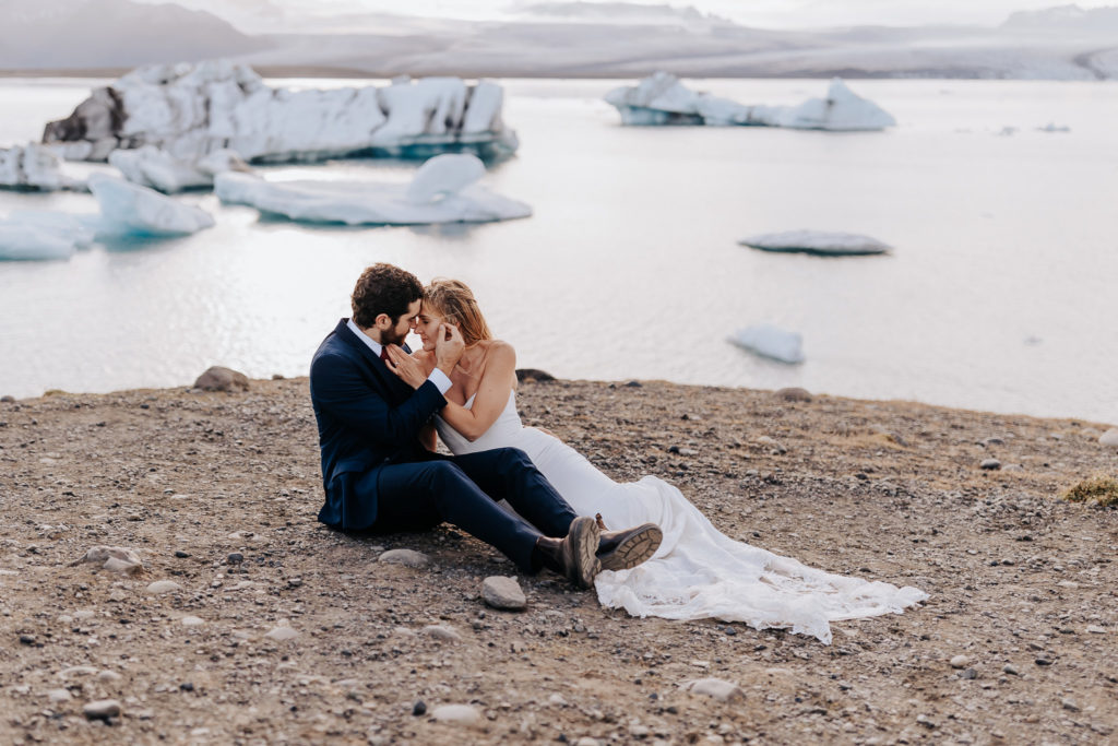 Iceland elopement photographer captures couple laying on beach together after Iceland elopement