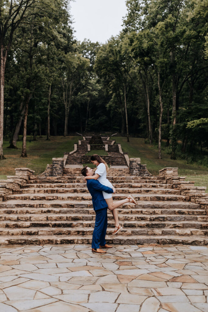 Nashville Wedding Photographer captures man lifting woman in air and kissing her at Percy Werner Steps