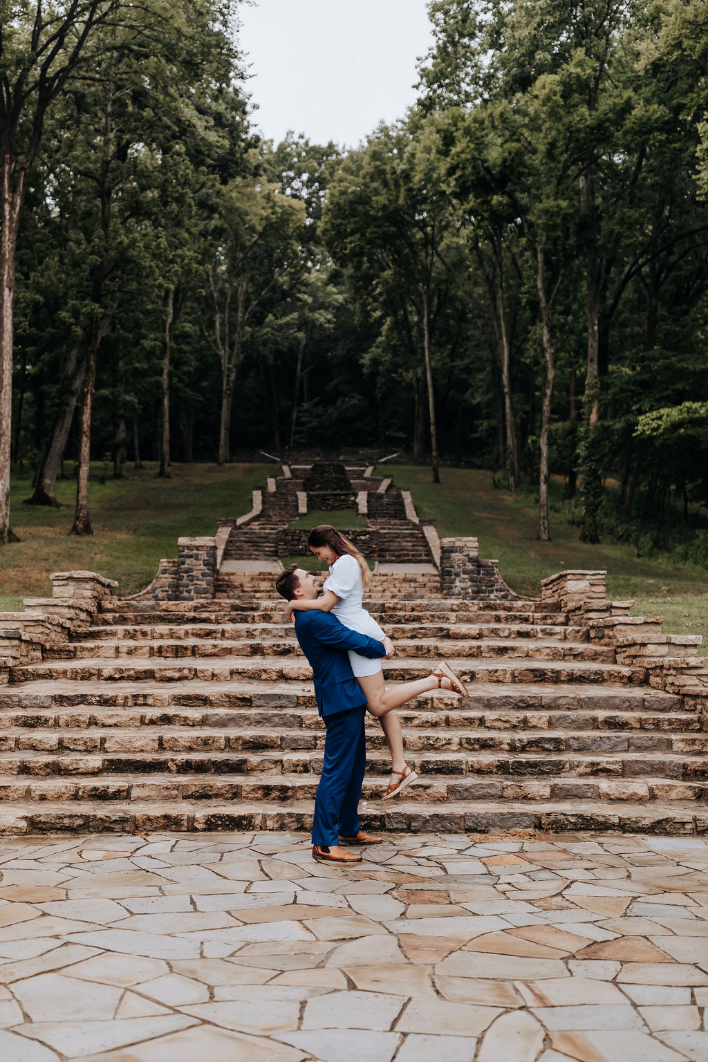 Nashville Wedding Photographer captures man lifting woman in air and kissing her at Percy Werner Steps