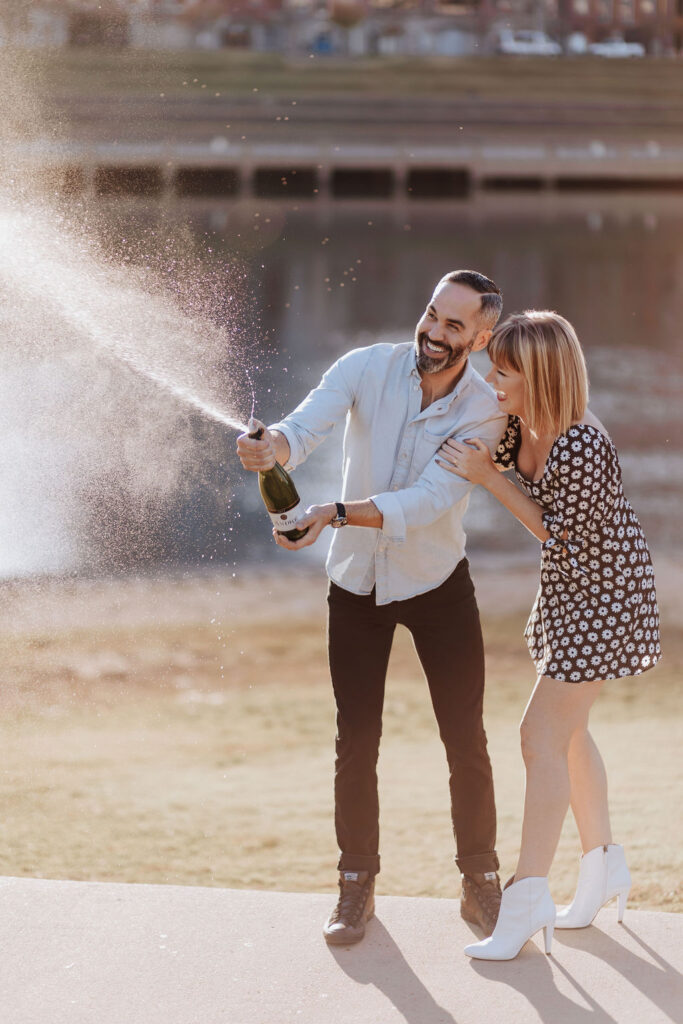 Nashville elopement photographer captures couple celebrating recent engagement with champagne pop