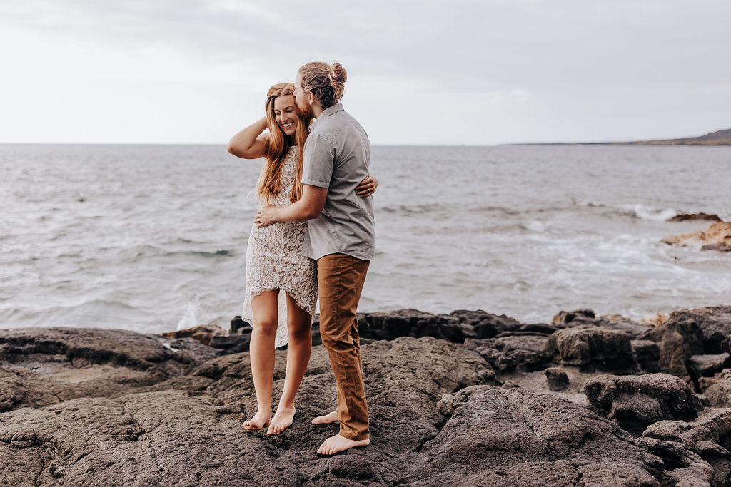 Big Island elopement photographer captures couple embracing at beach after elopement