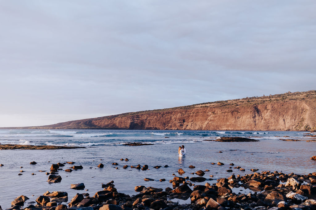 Big Island elopement photographer captures couple in ocean after outdoor Big Island elopement