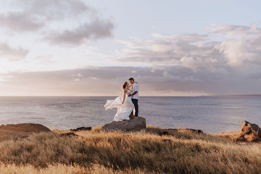 couple standing on cliff after destination elopement on the Big Island of Hawaii