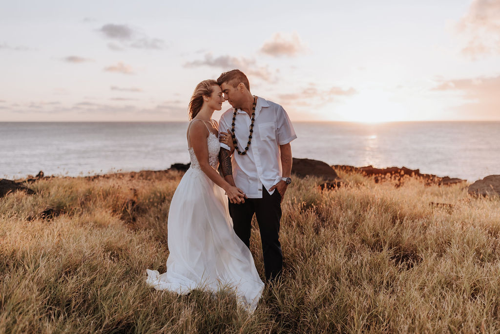 Big Island elopement photographer captures couple embracing after big island elopement on cliff overlooking ocean