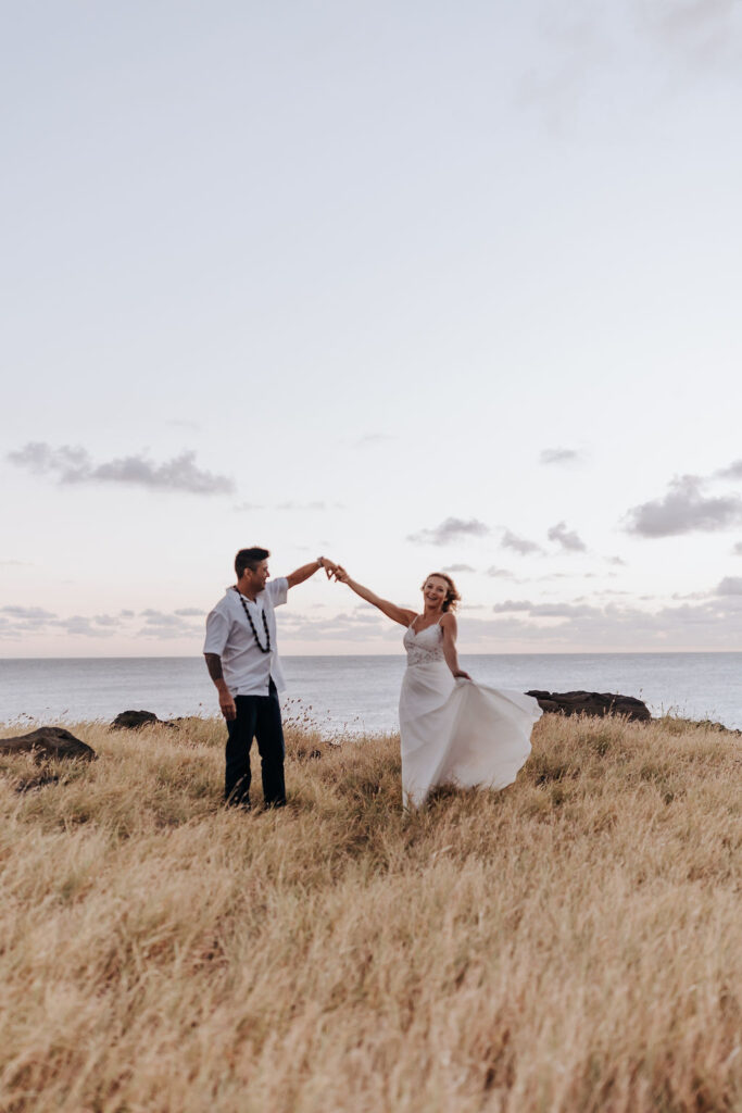 Destination elopement photographer captures couple dancing on top of mountain in Hawaii
