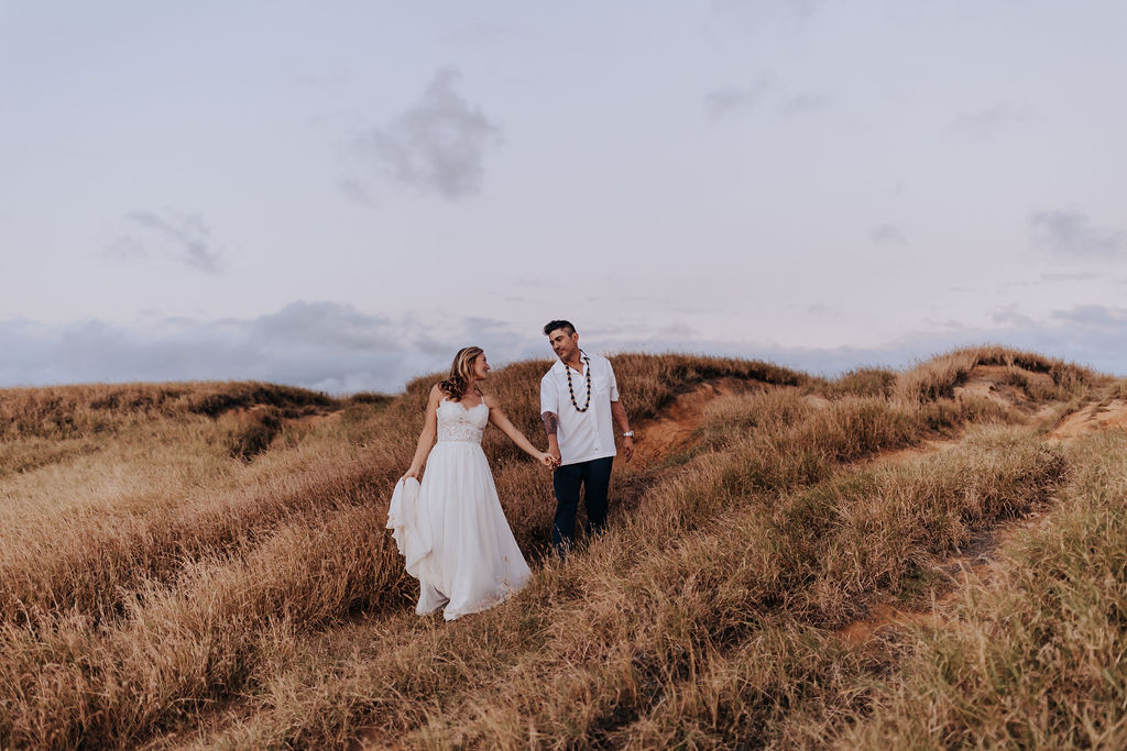Big Island elopement photographer captures couple walking through hill after Big Island elopement