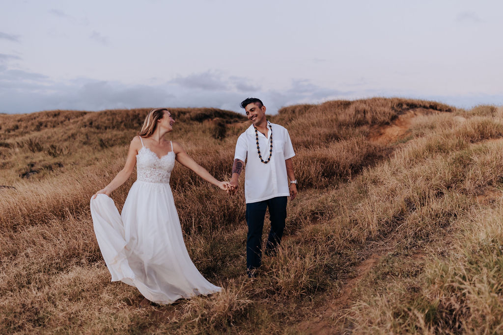 Big Island elopement photographer captures couple walking through hills after Big Island elopement