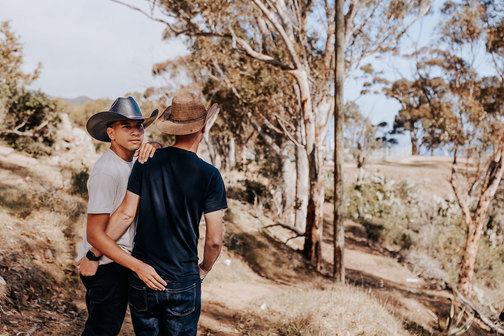 Nashville elopement photographer captures couple walking together wearing neutrals and cowboy hats