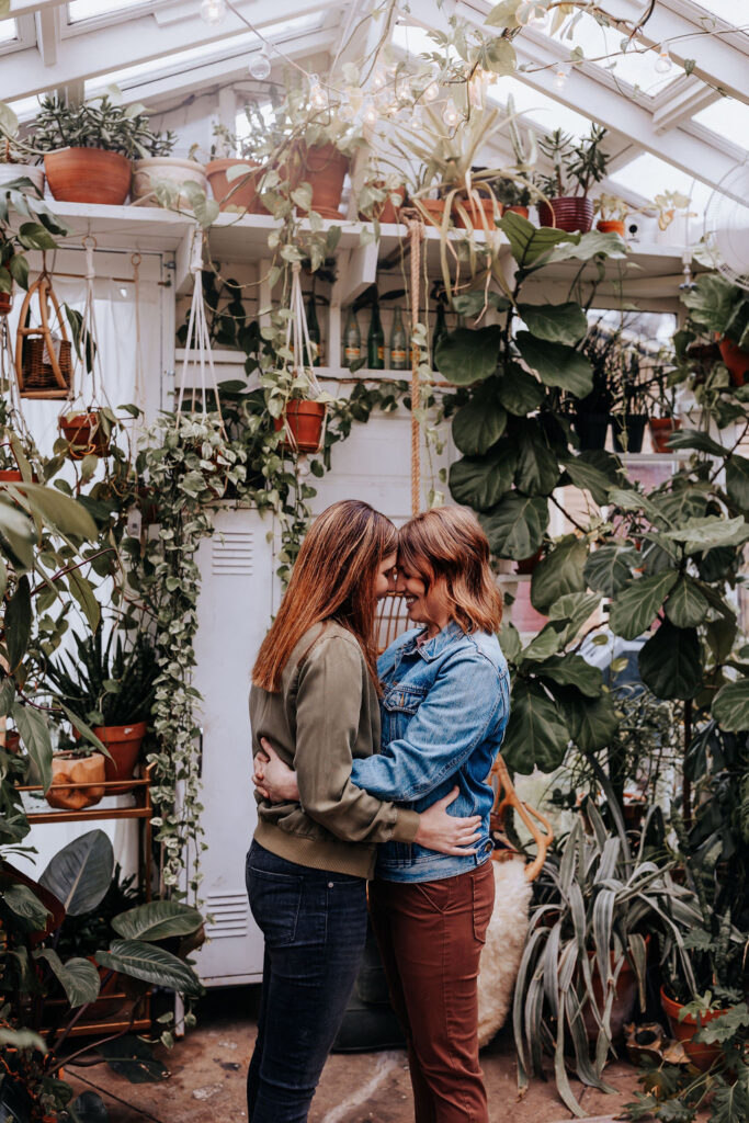 Nashville elopement photographer captures couple kissing and embracing in greenhouse 