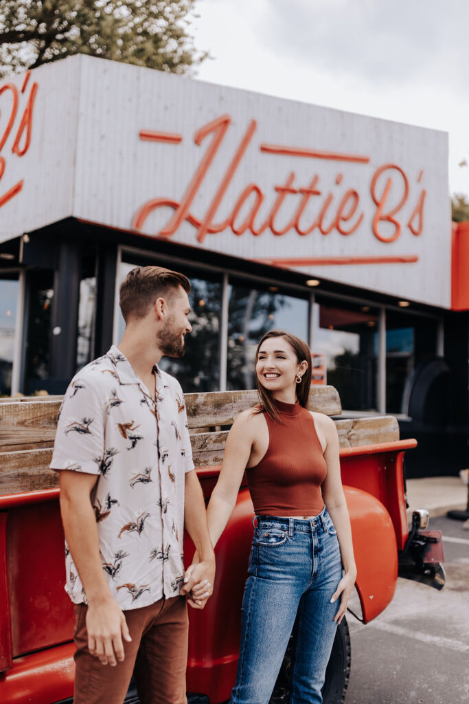 Nashville elopement photographer captures couple holding hands in front of favorite fast food restaurant, Hattie B's.