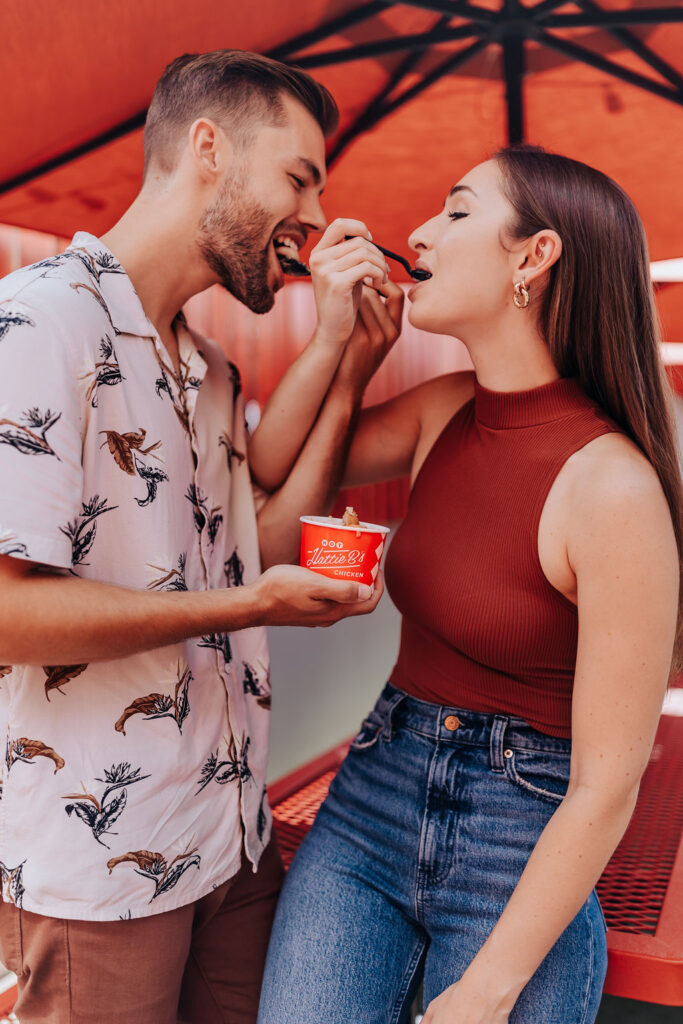 Nashville elopement photographer captures couple feeding one another food during unique engagement session