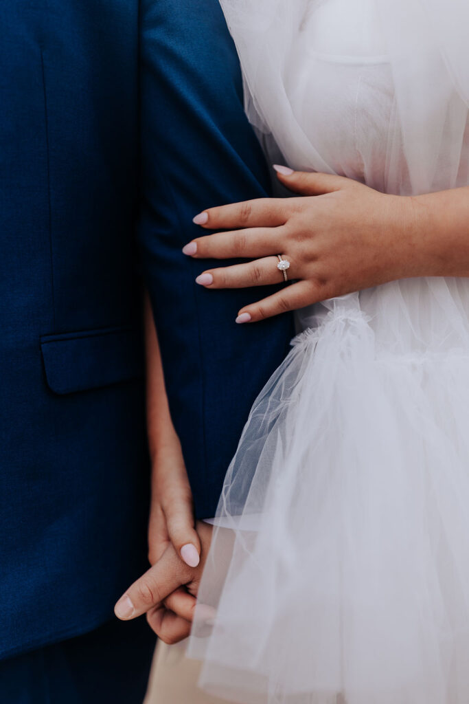 Nashville elopement photographer captures close up of bride holding groom's arm 