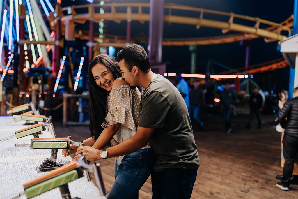 Nashville elopement photographer captures couple playing games at the carnival during engagement session