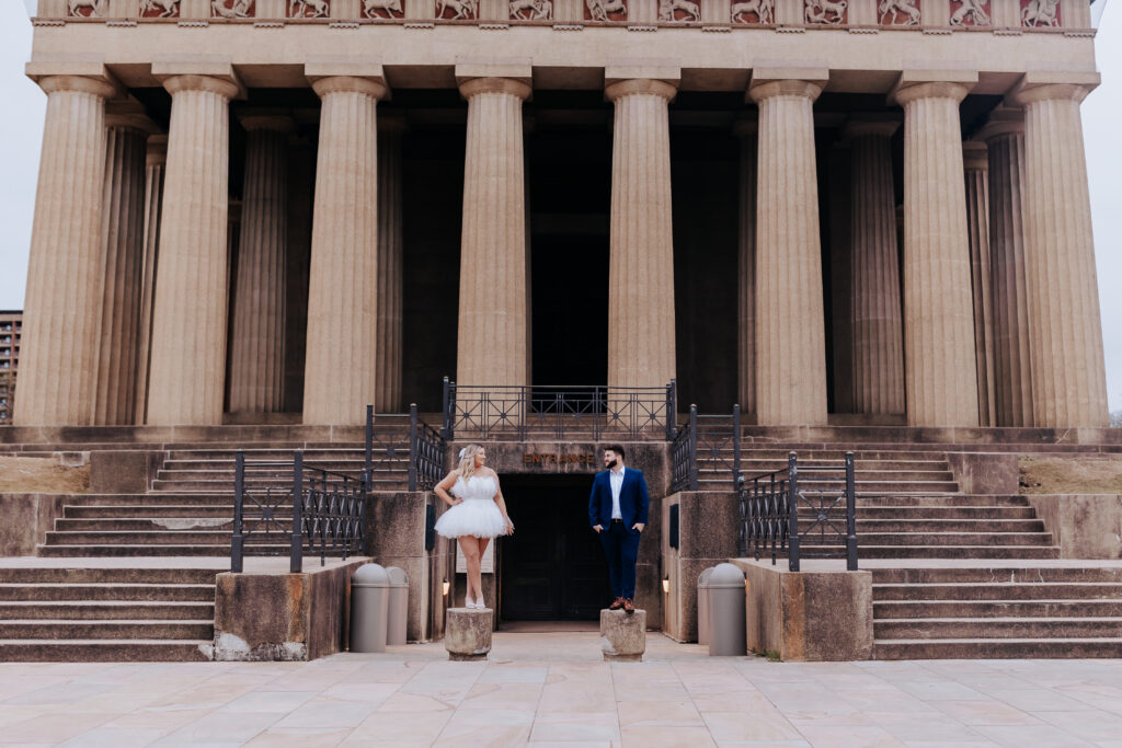 Nashville elopement photographer captures couple standing on columns during outdoor elopement