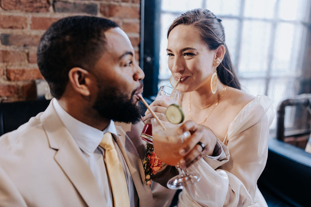 bride and groom sharing drink