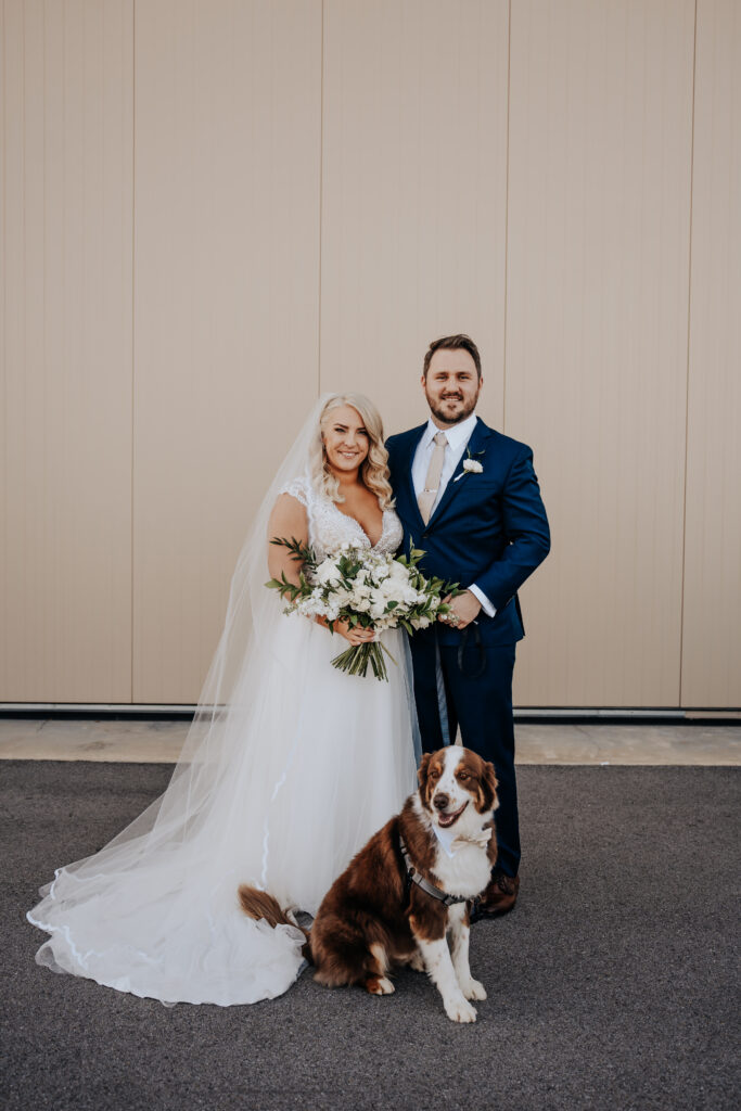 Nashville elopement photographer captures couple standing with pet during bridal portraits