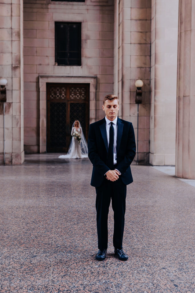 Nashville elopement photographer captures groom standing waiting for bride before first look