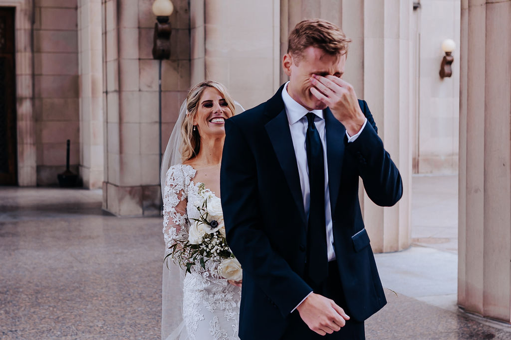 Nashville elopement photographer captures groom crying before first look with bride on rooftop Nashville wedding day