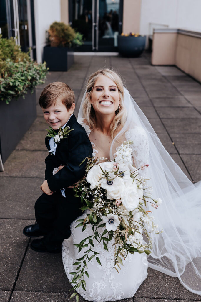 bride smiling with son on wedding day