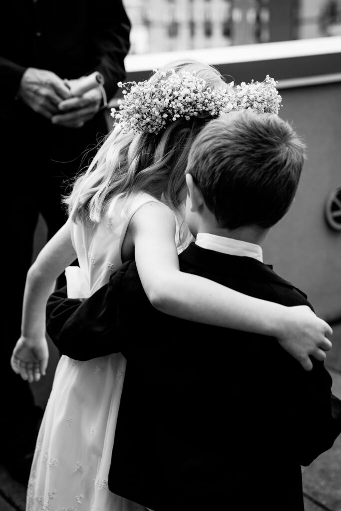 Nashville elopement photographer captures flower girl and ringbearer embracing while walking down aisle