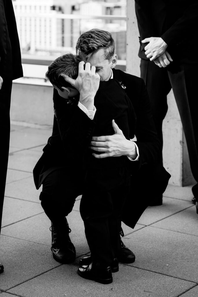 Nashville elopement photographer captures groom hugging son before wedding begins