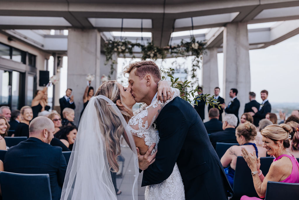 Nashville elopement photographer captures bride and groom kissing after rooftop downtown Nashville elopement