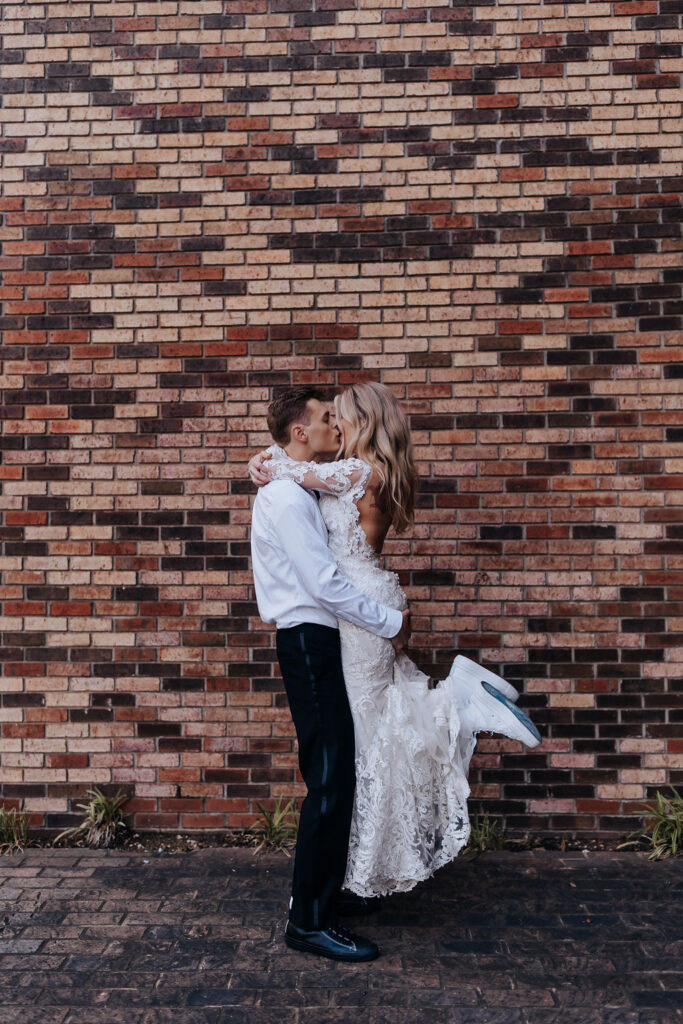 Nashville elopement photographer captures bride being lifted by groom during portraits