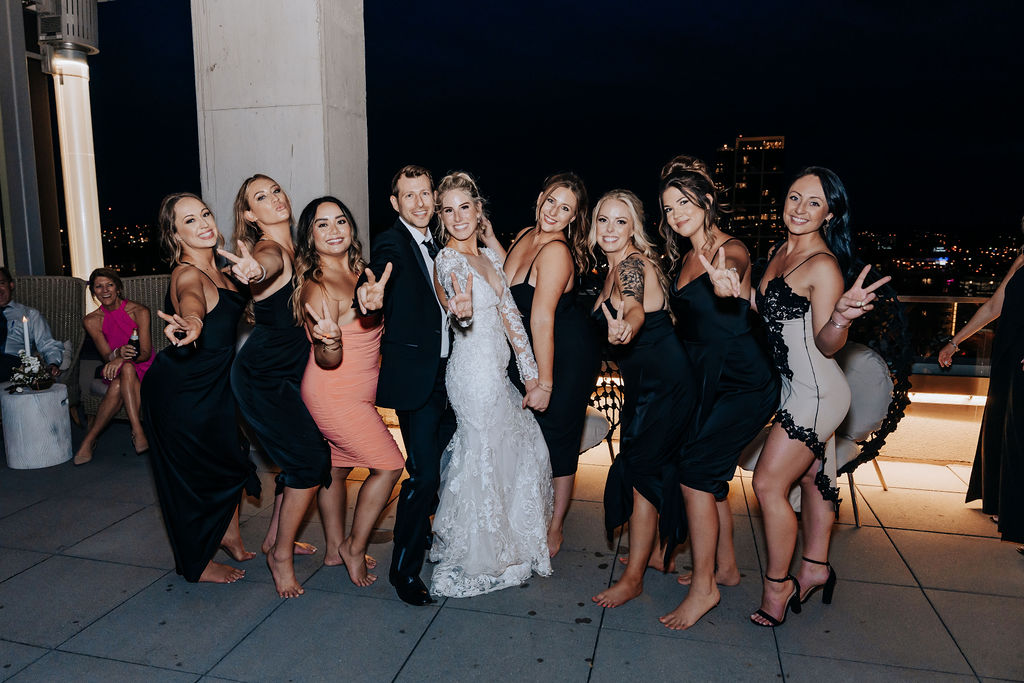 Nashville elopement photographer captures couple celebrating with friends and family at rooftop downtown Nashville wedding reception
