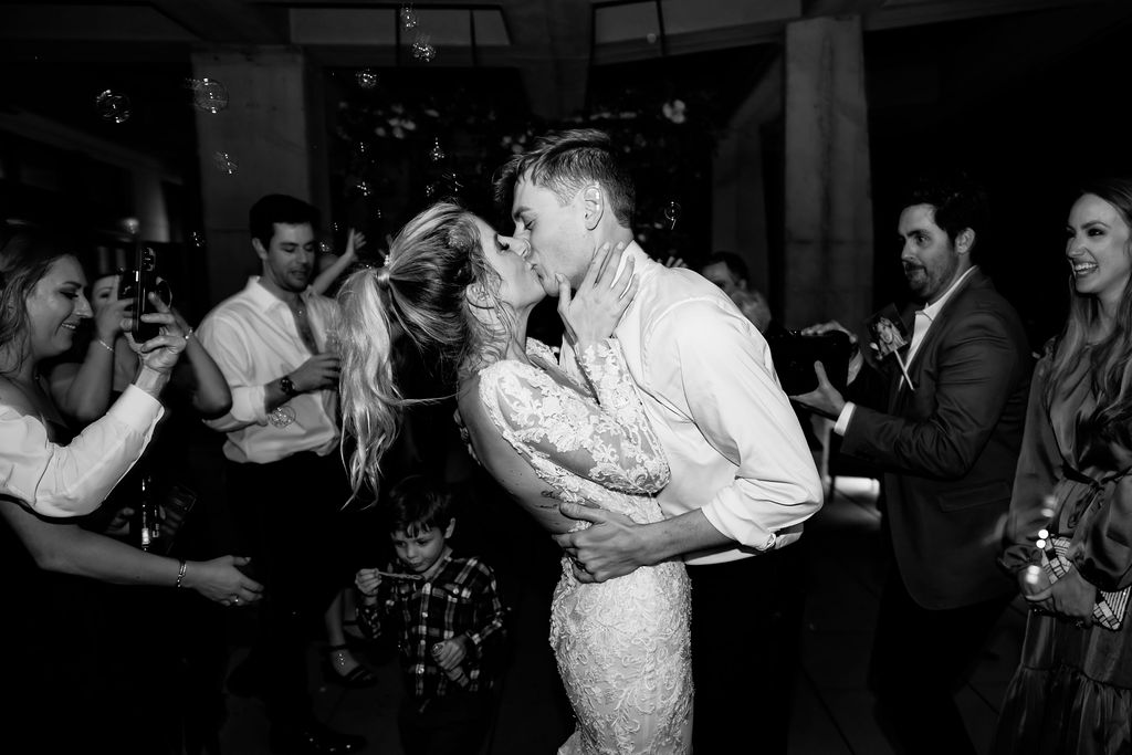 Nashville elopement photographer captures couple kissing during downtown Nashville wedding reception
