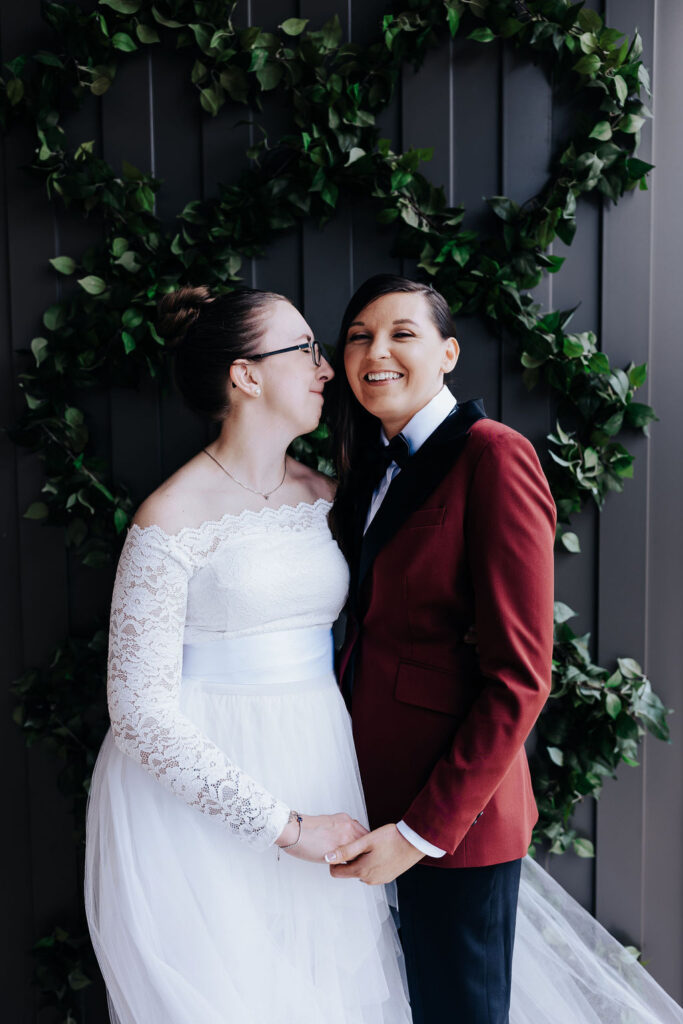 Nashville elopement photographer captures bride wearing wedding dress and bride wearing burgundy suit during portraits