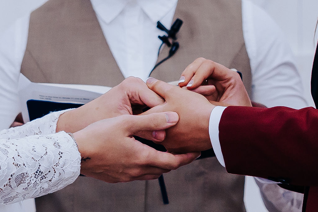 Nashville elopement photographer captures couple putting rings on one another finger