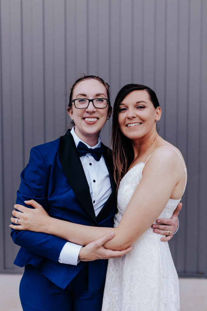 Nashville elopement photographer captures woman wearing blue suit and woman wearing bridal gown