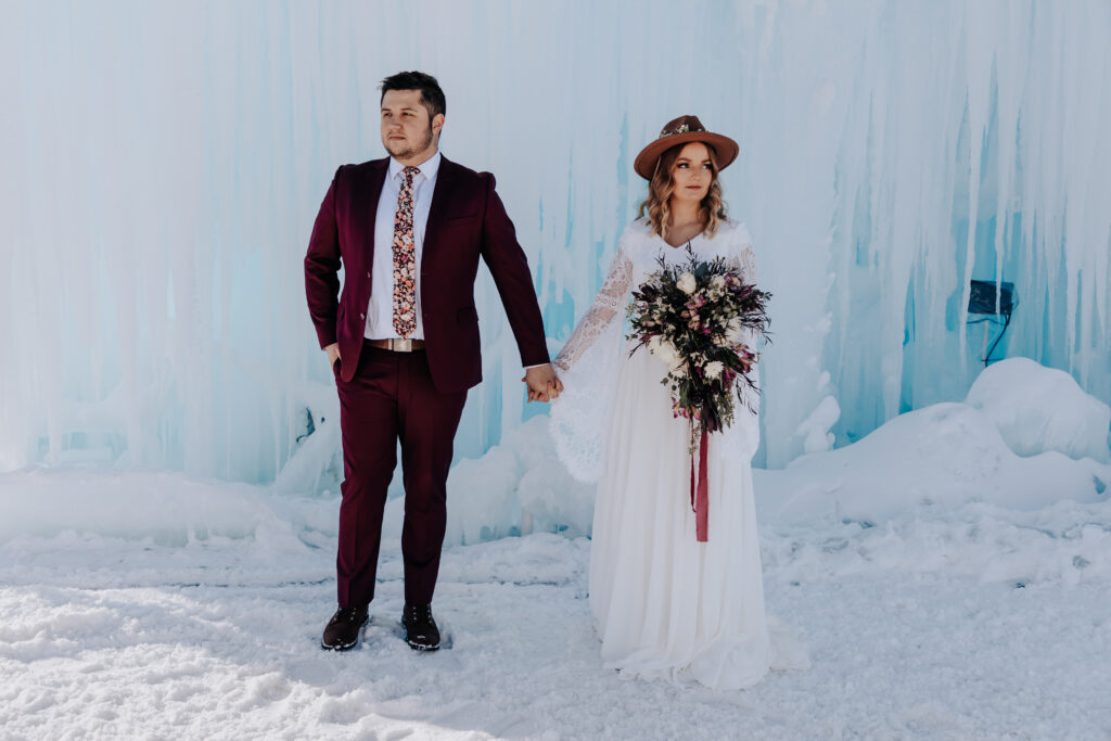 Nashville elopement photographer captures bride and groom holding hands at ice palace after winter wedding ceremony