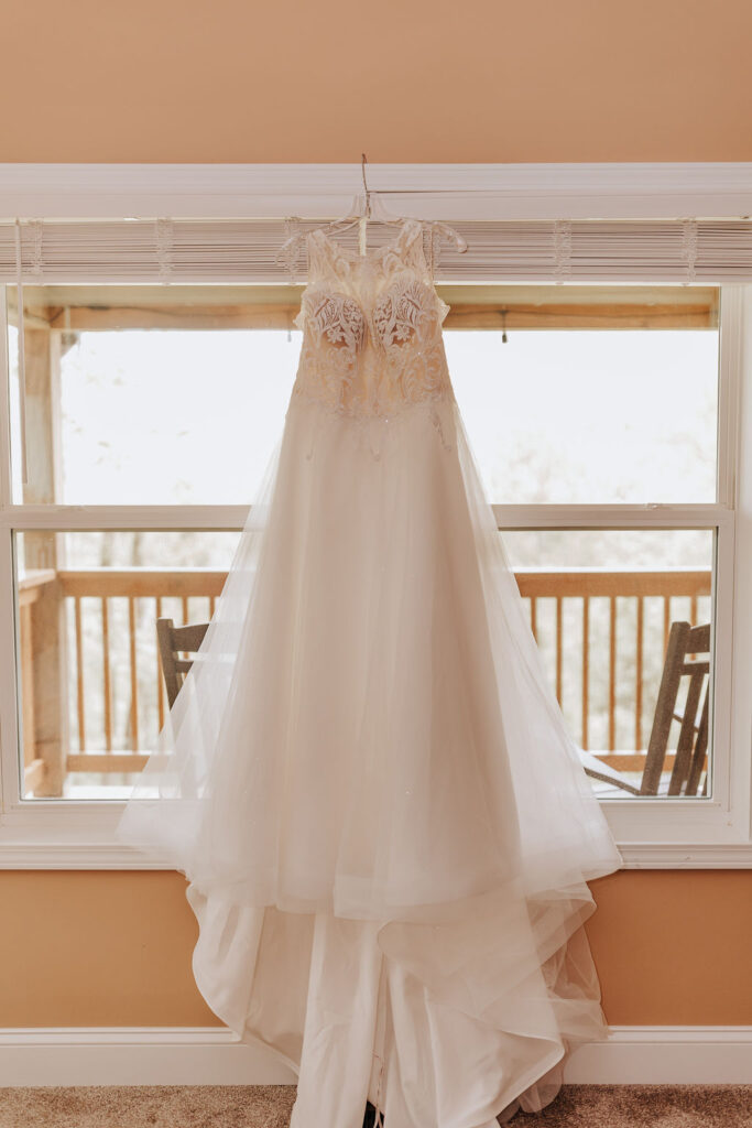 Nashville elopement photographer captures bride's wedding dress hanging from window
