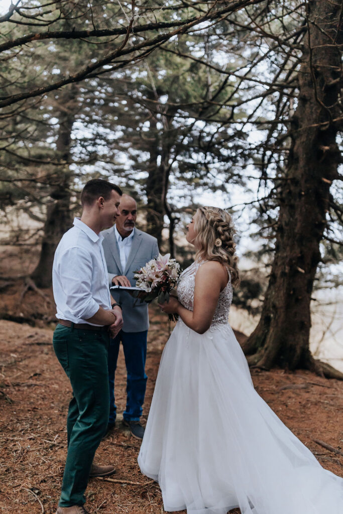Nashville wedding photographer captures bride and groom holding hands during wedding ceremony