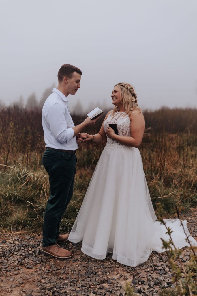 Nashville elopement photographer captures bride and groom reading vows during private vow reading