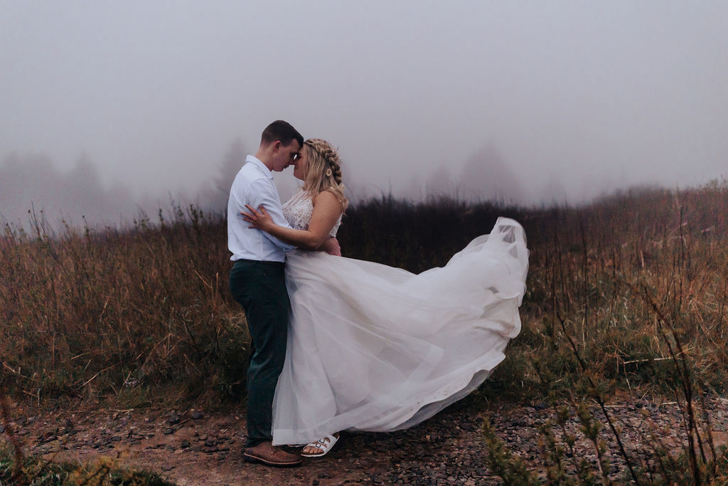 Nashville elopement photographer captures couple kissing during outdoor bridal portraits after Asheville cabin wedding