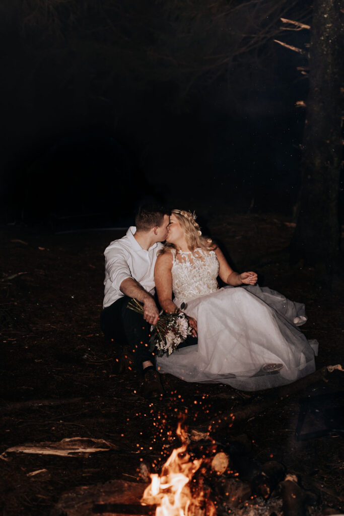 Nashville elopement photographer captures couple sitting by a fire after elopement