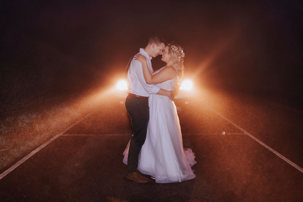 Nashville elopement photographer captures couple standing in front of headlights during bridal portraits